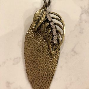 Brass colored long triple leaf necklace